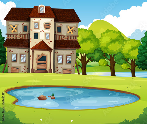 Old brick house with lawn and pond