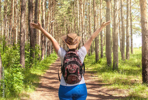 A young girl walks through the forest, walks in nature, the concept of tourism and travel