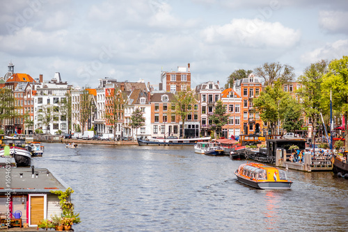 View on the beautiful old buildings and water channel in Amsterdam city