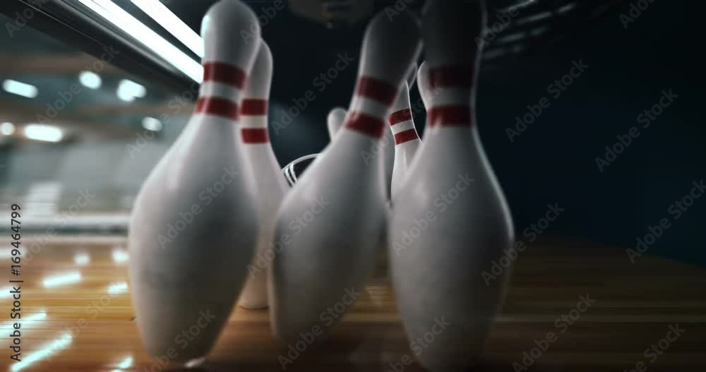 Bowling strike, bowling ball knocks down bowling pins in slow motion