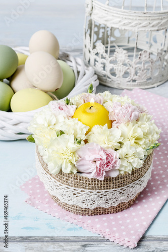 Easter floral arrangement with pink and yellow carnations.