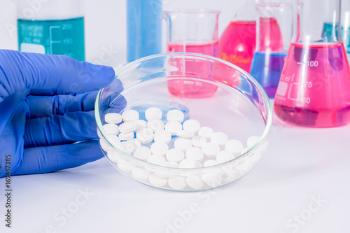 Scientist analyzing pills in medical laboratory. Analysis of medicaments in laboratory. Medical Research and diseases Science. photo