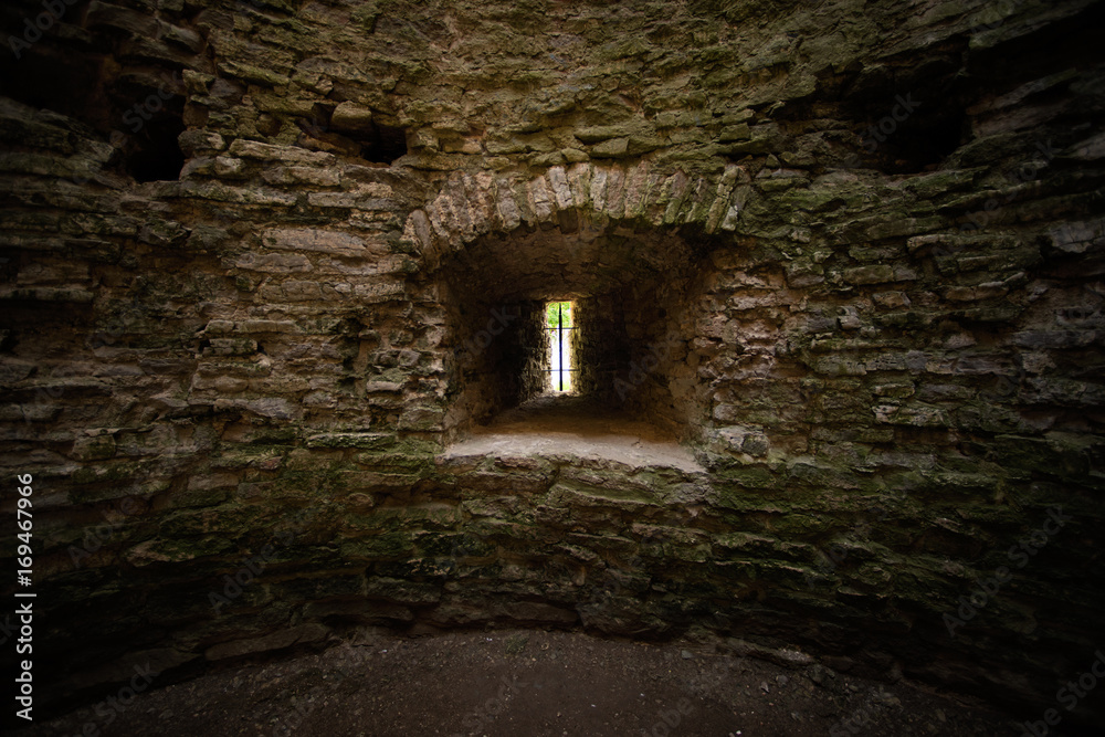 Window loophole in the ancient medieval limestone tower Window loophole in the ancient medieval limestone tower
