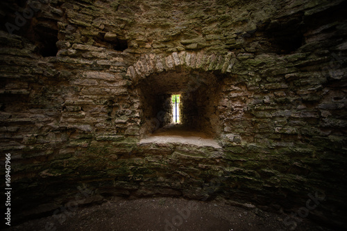 Fototapeta Naklejka Na Ścianę i Meble -  Window loophole in the ancient medieval limestone tower