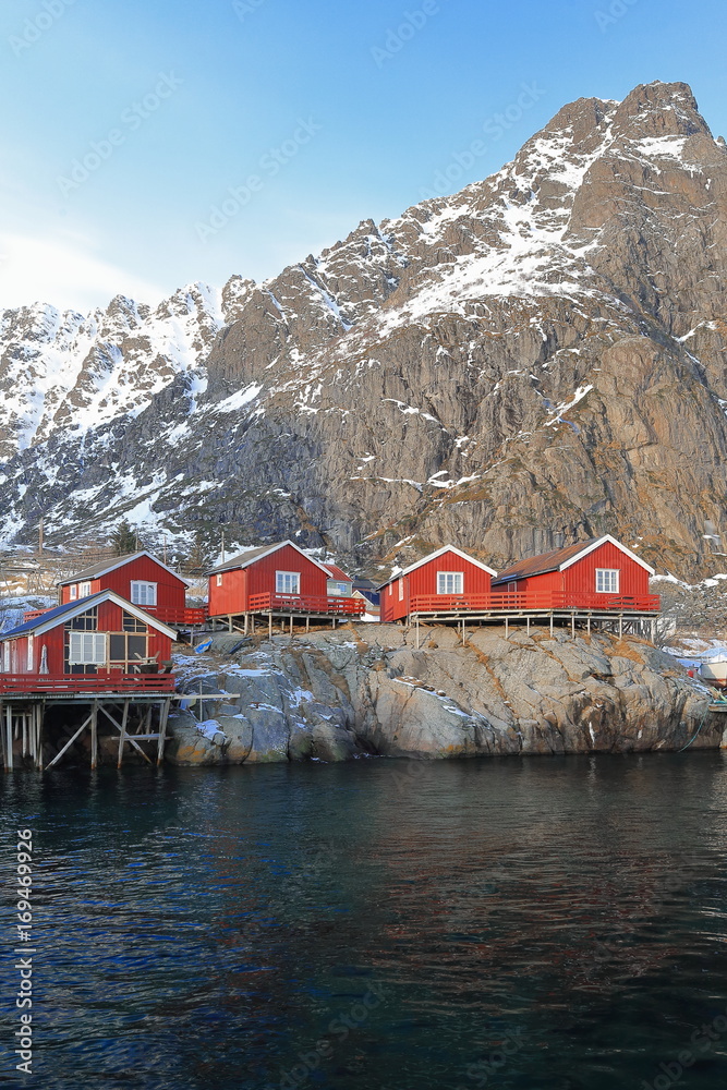 Red cottages-rorbuer in A i Lofoten. Tinddalstinden-Stottlikollen mounts background. Sorvagen-Moskenesoya-Nordland-Norway.0324