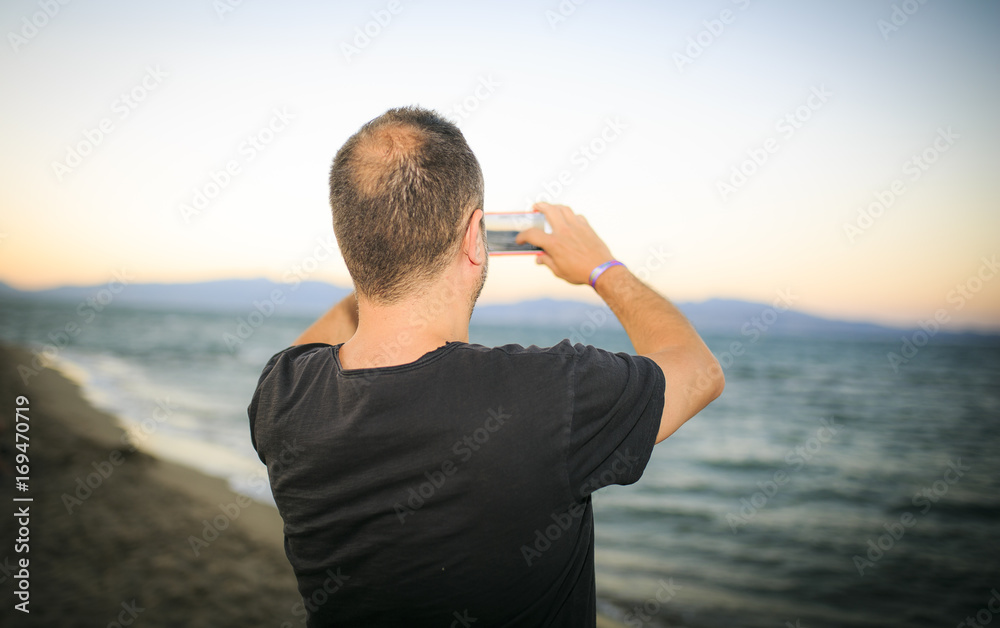 man making a photo on the beach man making a photo on the beach
