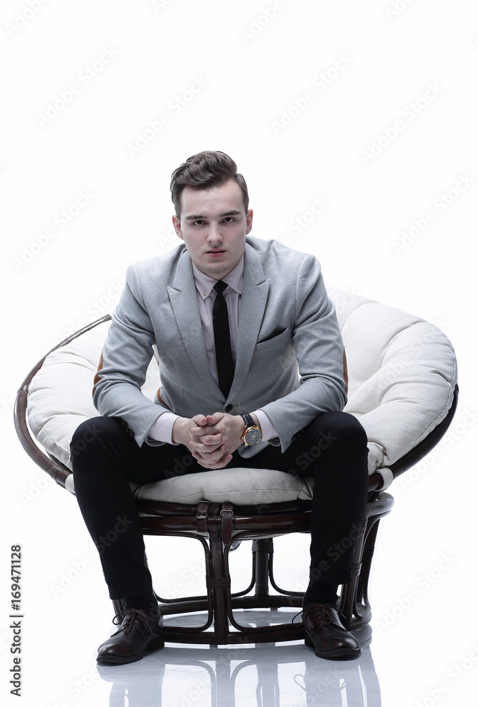 tired businessman sitting in a round chair made of rattan tired businessman sitting in a round chair made of rattan