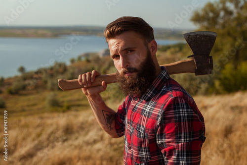 Young hipster man with axe photo