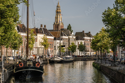 Groningen, Groningen - 22 augustus 2017: View over a canel in Groningen with the A-kerk in the back photo