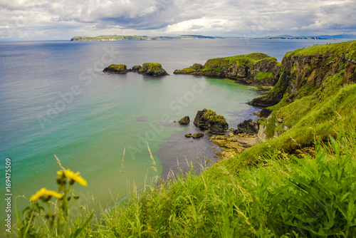 Cliffs of Carrick-a-rede rope bridge in Ballintoy, Co. Antrim. Landscape of Northern Ireland.Traveling through the Causeway Coastal Route. 