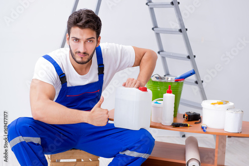Fotografie Repairman doing renovation repair in the house with paper wallpa