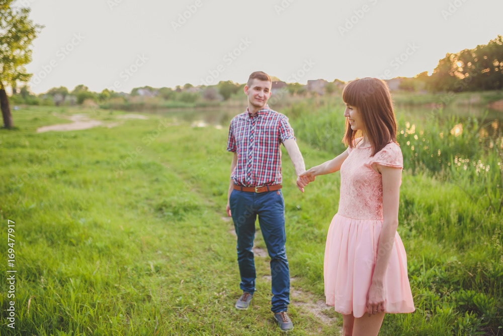 Young couple in love, Attractive man and woman enjoying romantic evening on the beach Young couple in love, Attractive man and woman enjoying romantic evening on the beach