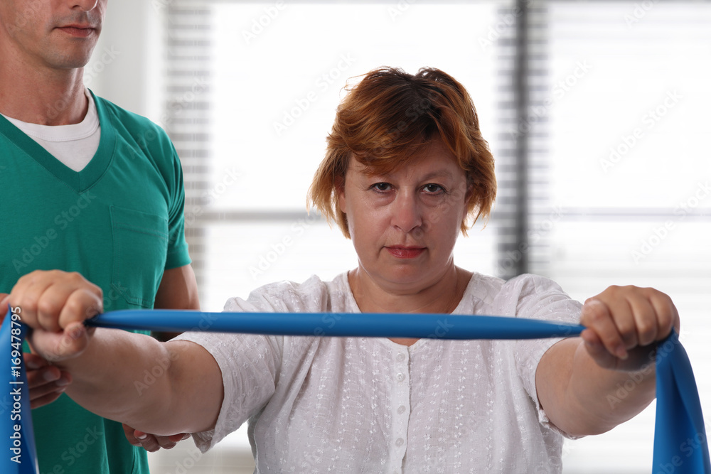 Obraz premium Woman having chiropractic back adjustment. Osteopathy, Alternative medicine, pain relief concept, Physiotherapy, injury rehabilitation treatment with Resistance Band.