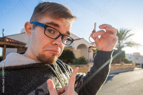 Property, ownership, new home and people concept - Young man moving into new home photo