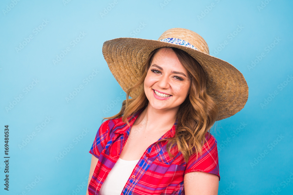 Portrait of beautiful woman in hat on blue background and copy space