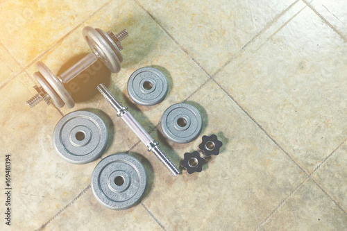 Iron Dumbbells on the floor showing all parts of it.
