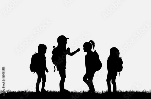 Silhouette of a child with a backpack .
