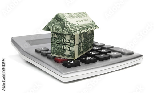 Calculator With Origami Cash House. photo