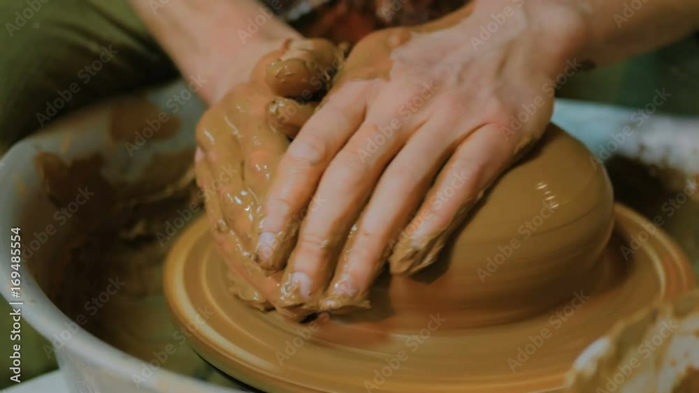 Professional male potter making bowl in pottery workshop, studio. Close up shot of potter's hands. Handmade, small business, crafting work concept Professional male potter making bowl in pottery workshop, studio. Close up shot of potter's hands. Handmade, small business, crafting work concept