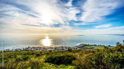 Sun setting over the Atlantic Ocean, Sea Point and Camps Bay. Viewed from Signal Hill at Cape Town, South Africa