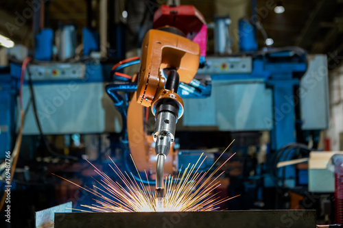 Robots welding in a car factory. Welding car body