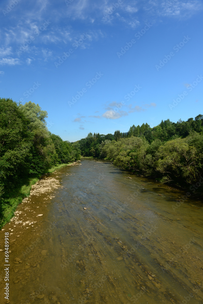 Landscape with wild river and blue sky