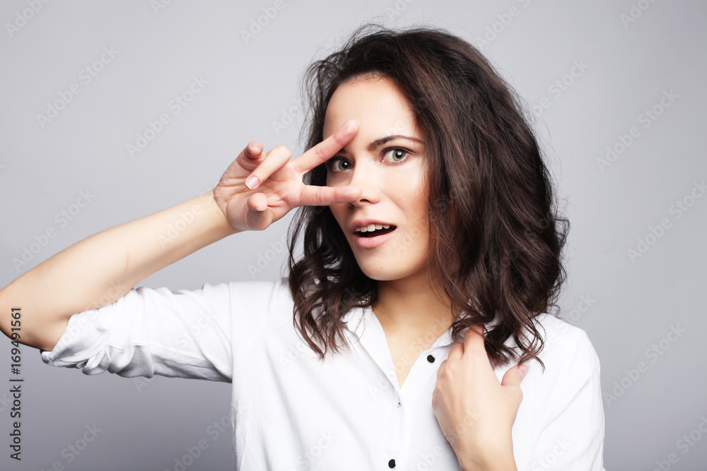young lovely woman showing victory or peace sign young lovely woman showing victory or peace sign