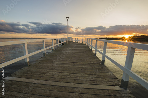 Sunset on the lake  wooden  white pier