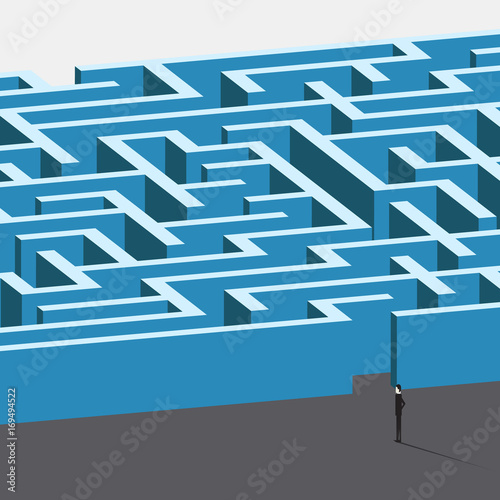 Businessman standing in front of huge maze as a symbol of business challenge and overcoming. Business challenge. Group People in  front of huge maze as a symbol of business challenge.