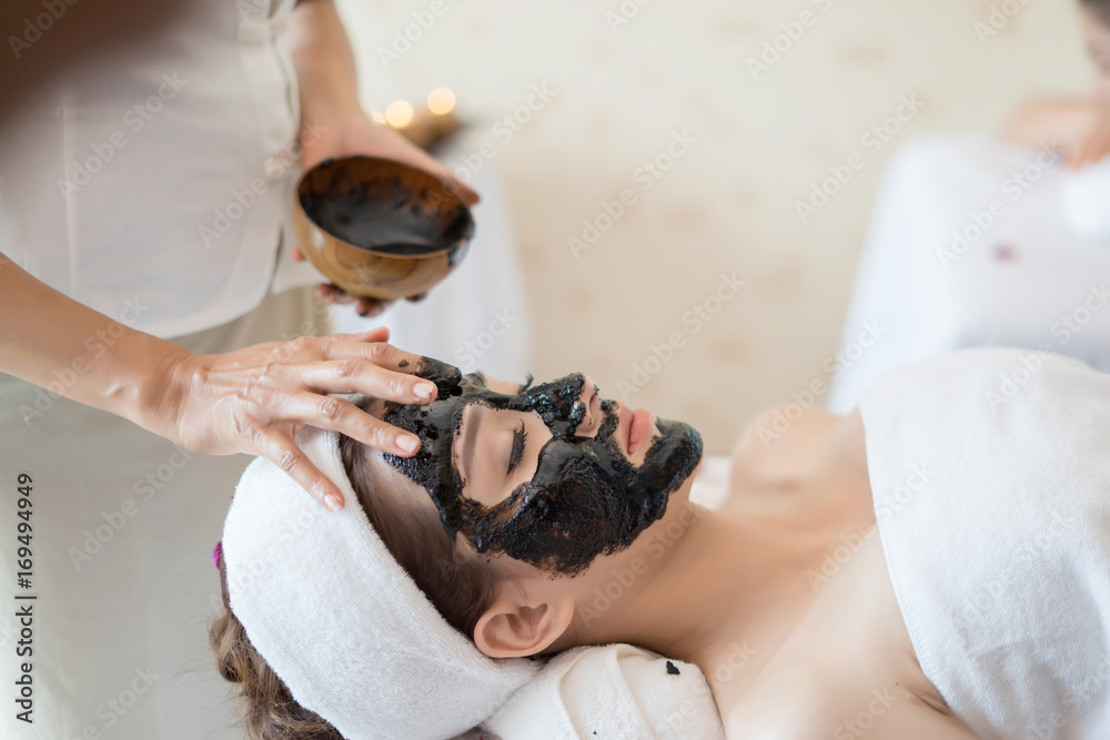 Εκτύπωση καμβά Young beautiful woman in a mask for the face. Beauty concept.