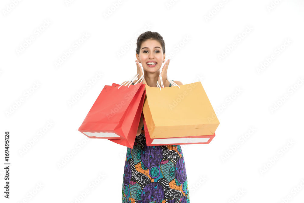 Young beautiful woman holding shopping bags over white background Young beautiful woman holding shopping bags over white background