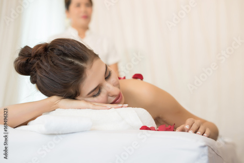 Young beautiful woman with healthy massage of body in the spa salon. Beauty concept.