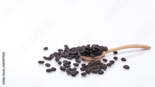 Coffee beans are in a wooden spoon, white background.