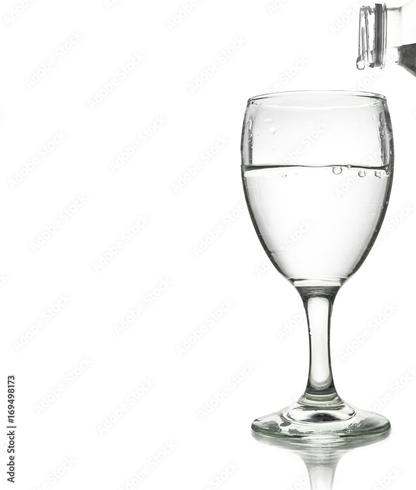 pouring water on a glass isolated on white background. Clipping path pouring water on a glass isolated on white background. Clipping path
