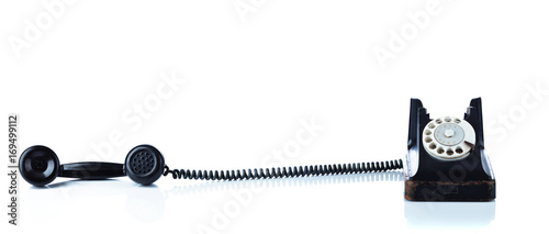 Old black phone isolated on  white.