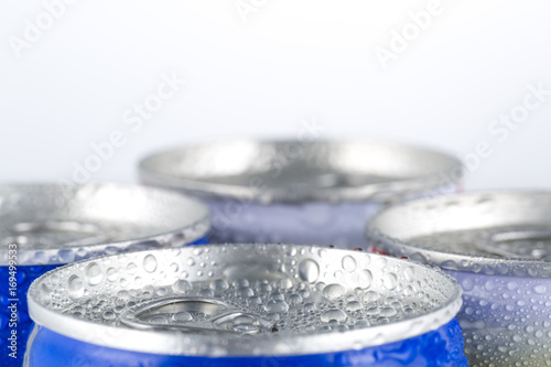 Many cans of cold beer with condensation water droplets.