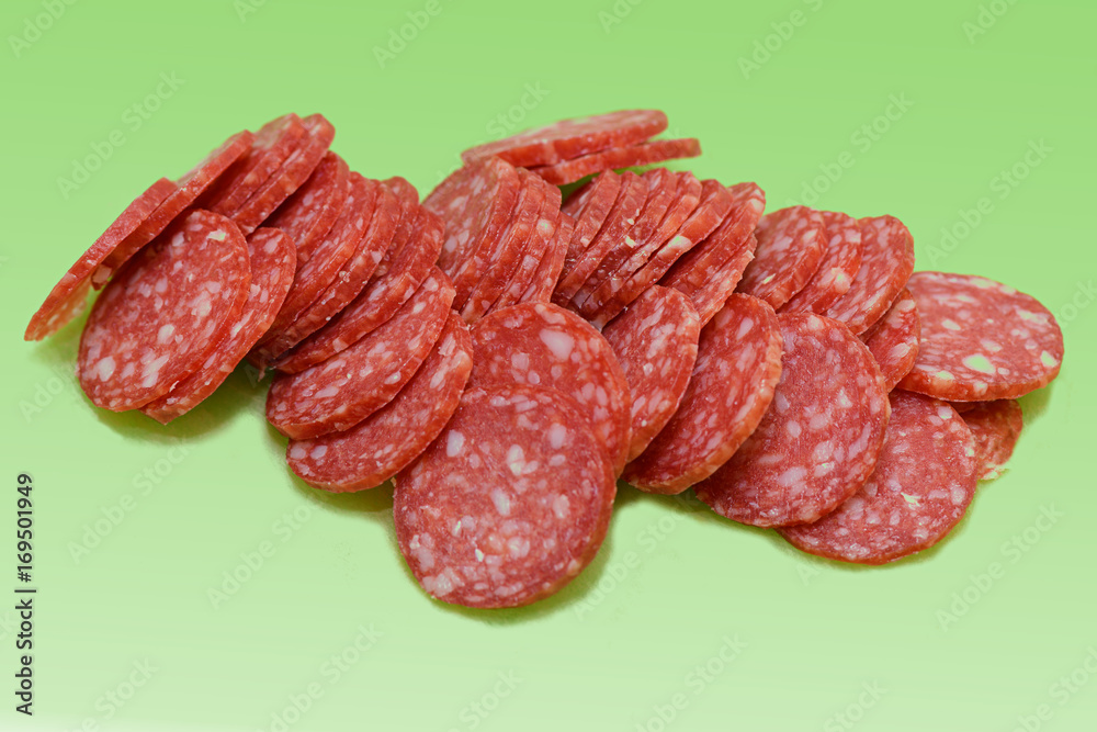sliced smoked sausage on a green background sliced smoked sausage on a green background
