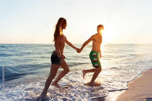 Happy young couple enjoying the sea