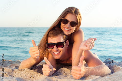 Happy Couple in Sunglasses Having Fun on the Beach © fotofabrika