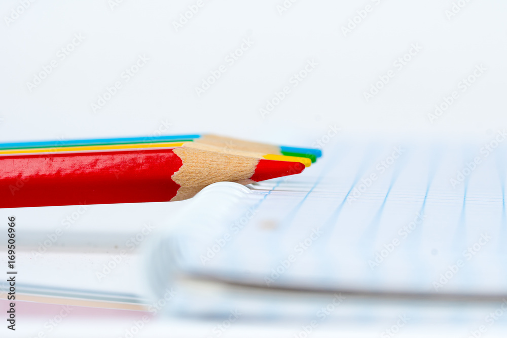 Obraz premium four colorful pencils with notepad, education concept