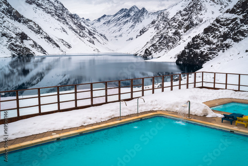 Snow Mountains, Resort Lake. Peak View, Rocks. Beautiful Background Cliff. Mountain Landscape Wallpaper. Isolated Snow Background. Outdoor Swimming pool. Winter Snow Spa Background Wallpaper. Panorama