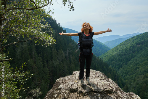 Happy hiker on mountain peak