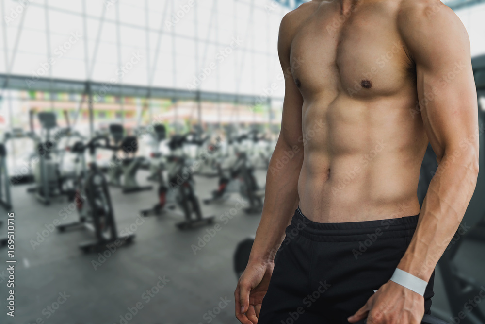 Handsome young Asia Male bodybuilder, fitness model trains in the gym Handsome young Asia Male bodybuilder, fitness model trains in the gym