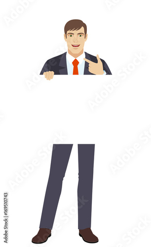 Businessman holding white blank poster and pointing at himself