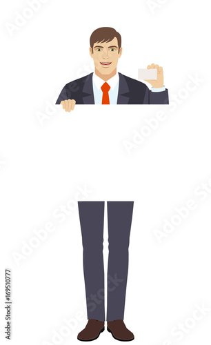 Businessman holding white blank poster and showing the business card