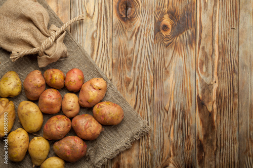 Potatoes on a rustic wooden background