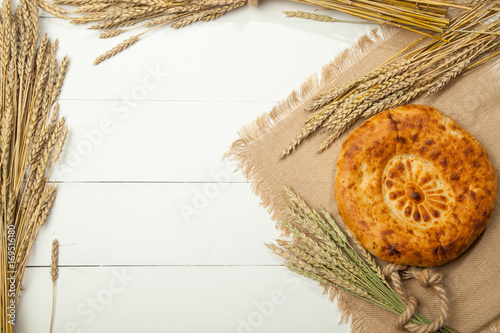 Asian flat cake and wheat on white background photo