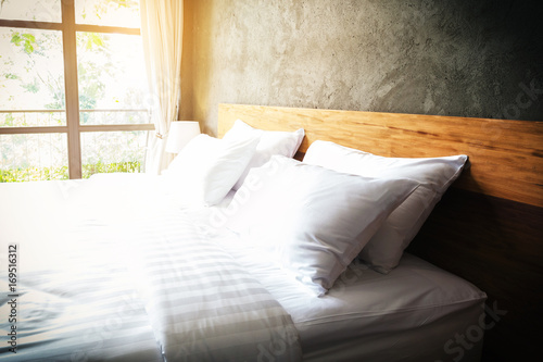close up Bedroom Suite interior with white pillows and wall concrete background