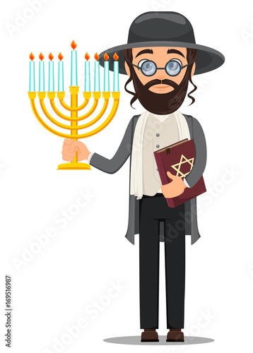 Rosh Hashanah. Jew man in traditional clothes holding bible and menorah. photo