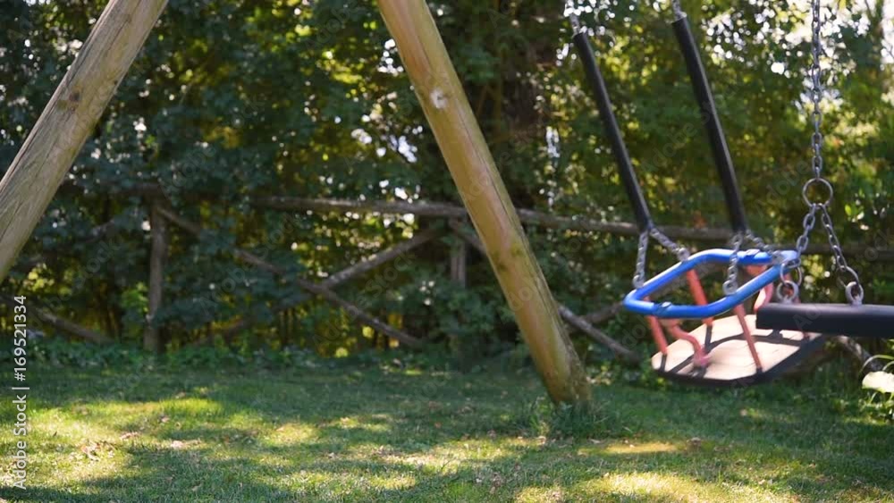 empty swing seats on playground without children empty swing seats on playground without children